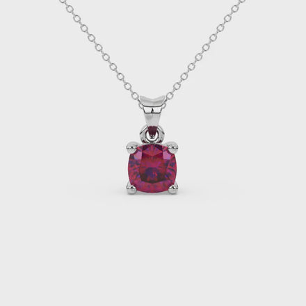 Red cushion cut solitaire gemstone pendant in yellow gold four-prong setting