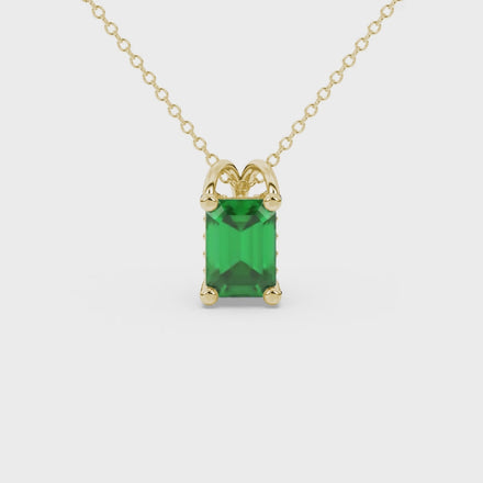 Emerald cut green gemstone solitaire pendant in yellow gold four prong setting