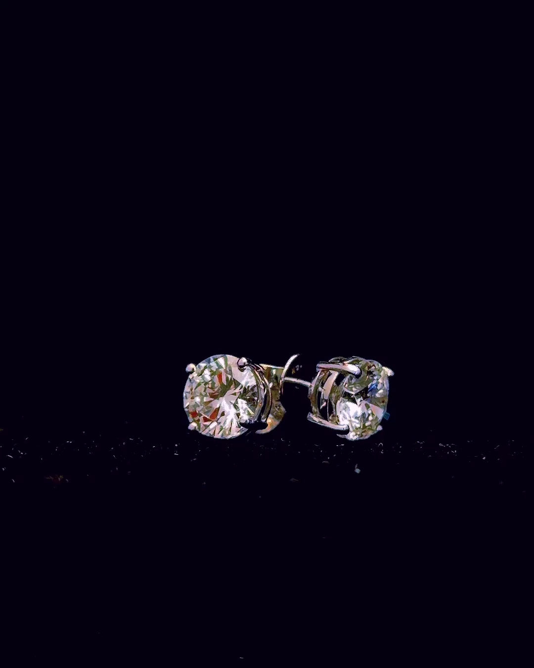 White gold round 4-prong stud earrings with 5.01ct total lab grown diamonds on black