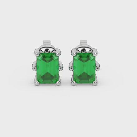 Emerald cut green gemstone solitaire stud earrings in gold with six prong setting
