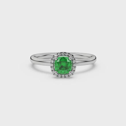 Green cushion cut gemstone halo ring with diamond accents in gold