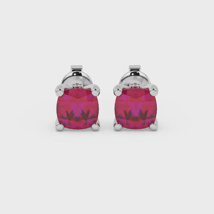 Red cushion cut solitaire stud earrings with accent diamonds in white gold four prong setting