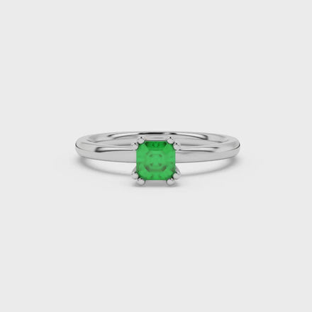 Green Asscher cut gemstone solitaire ring in gold featuring a refined six-prong basket setting
