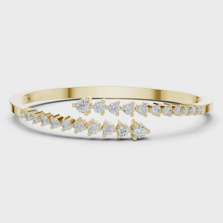 Graduated round lab grown diamond open cuff bracelet with flowing diamond design in yellow white and rose gold