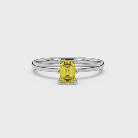 Emerald cut yellow gemstone solitaire ring in six prong gold setting