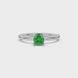 Green cushion cut gemstone solitaire ring in gold featuring a refined four-prong cathedral basket setting