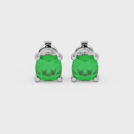 Green cushion cut solitaire stud earrings with accent diamonds in white gold four prong setting
