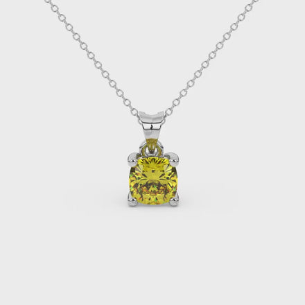 Yellow cushion cut gemstone pendant with accent diamonds in yellow gold basket setting