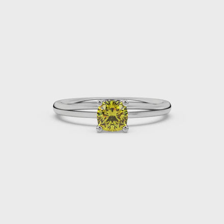 Yellow cushion cut gemstone ring with diamond gallery detailing in yellow gold