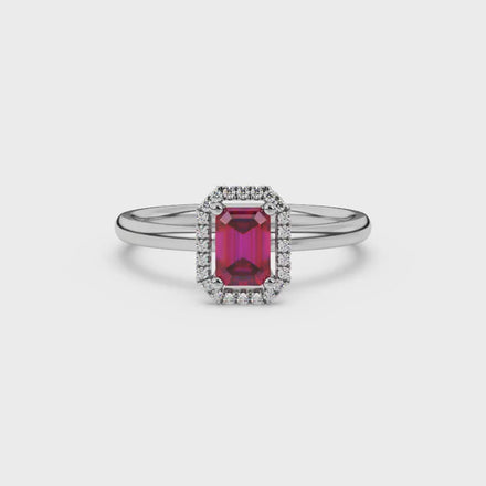 Red emerald cut gemstone halo ring with split shank band and diamond accents