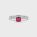 Red cushion cut solitaire gemstone ring in six-prong gold setting with slim stackable band