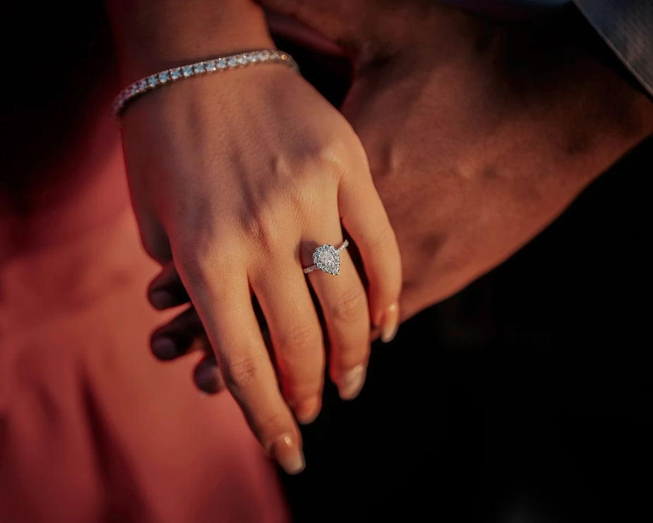 A woman's hand wearing a pear-cut lab-grown diamond engagement ring